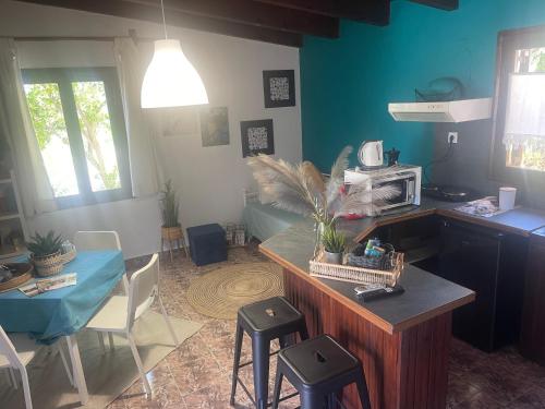 a kitchen and dining room with a table and a microwave at Villas Vista Del Mar in Kissamos
