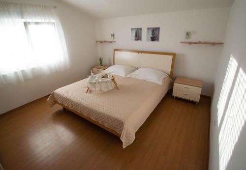 a small bedroom with a bed and a window at Apartments Anita Frane in Vodice