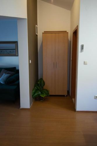 a living room with a cabinet and a plant at Apartments Anita Frane in Vodice