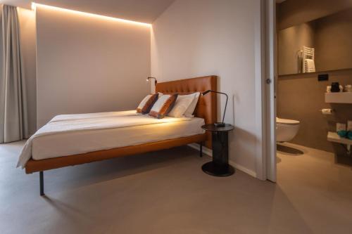 a bedroom with a bed and a toilet in it at Hotel Meridiana in Malcesine