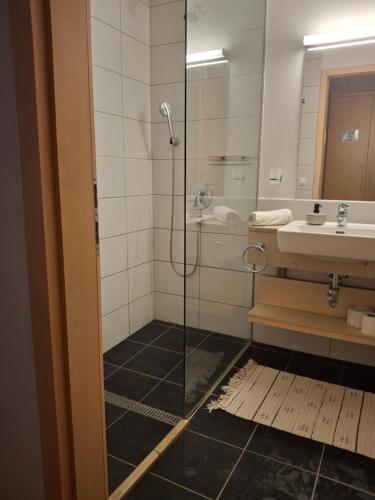 a bathroom with a shower and a sink at Füred Central Apartman in Balatonfüred