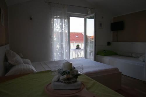 a bedroom with a bed and a window with a view at Apartments Anita Frane in Vodice