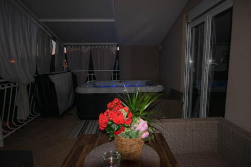 a living room with a table with flowers on it at Apartments Anita Frane in Vodice
