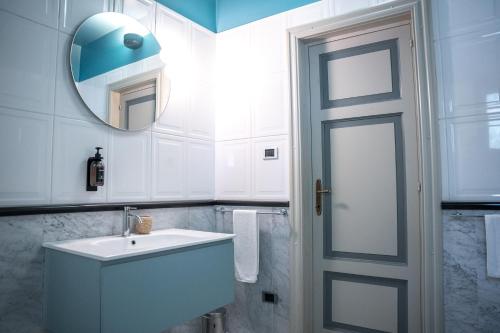a bathroom with a white sink and a mirror at Sella&Mosca Casa Villamarina in Alghero