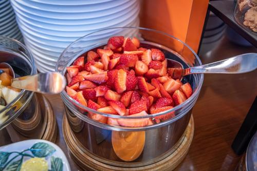 a bowl of strawberries sitting on a table at Hotel Meridiana in Malcesine