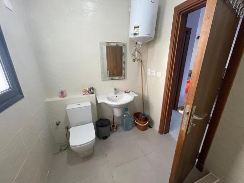 a bathroom with a white toilet and a sink at Mohamed Afifi GAIA Ras El-Hekma - Penthouse 2BR- Families Only in Ras Elhekma