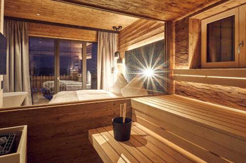 a room with a sauna with a bed and a window at Hunderesort Waldeck - 4 Sterne Urlaub mit Hund in Philippsreut
