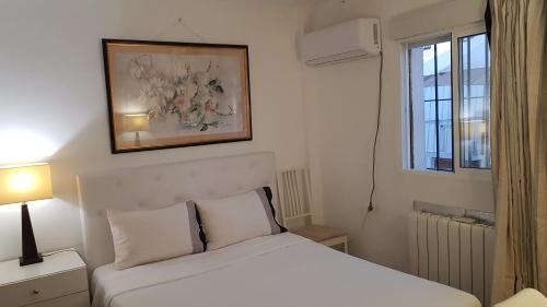 a bedroom with a white bed and a window at LITTLE PEACEFUL RETREAT Room with bath, Heating, Terrace, Free Wifi Fridge Easy parking in Nueva Andalucia