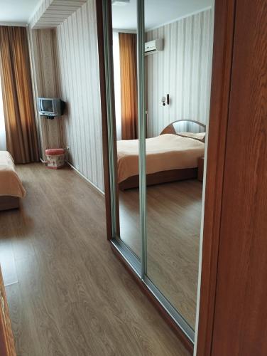 a mirror in a room with a bed and a bedroom at Hotel IUG in Taraclia