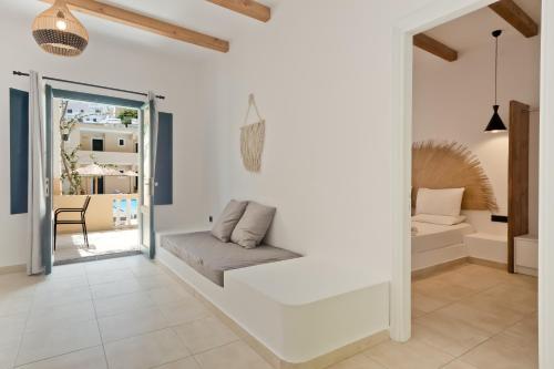 a living room with white walls and a couch at Kyra Panagia Hotel in Kyra Panagia