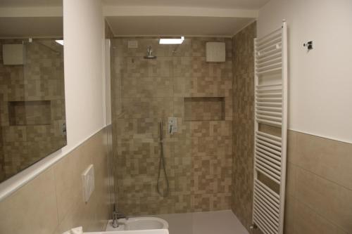 a bathroom with a shower with a toilet and a sink at B&B San Francesco Class in San Pellegrino Terme