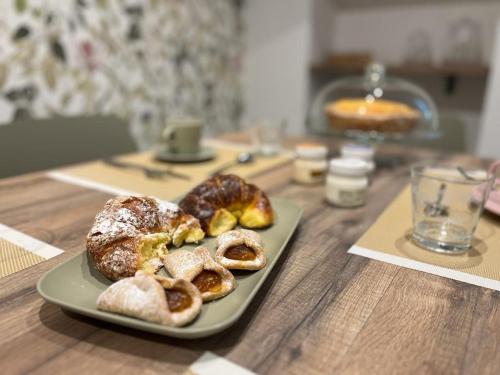 a plate of pastries on a wooden table at B&B San Francesco Class in San Pellegrino Terme