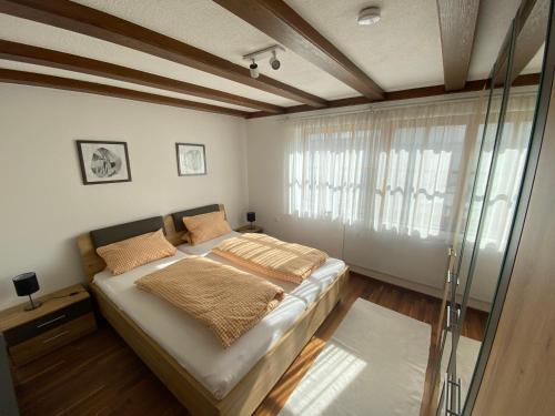a bedroom with a bed and a glass window at Ferienwohnung Mayer in Bad Schussenried