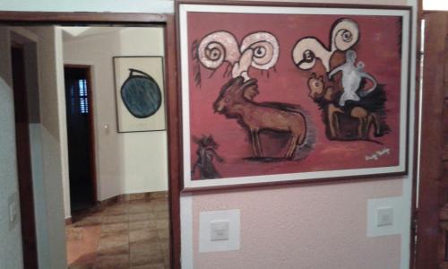 a painting of animals on the wall of a hallway at Apartmani Vila Marija in Budva