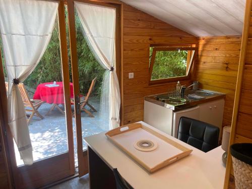 a kitchen with a stove and a sink and a table at Gites au Château des Estubiers in Les Granges-Gontardes