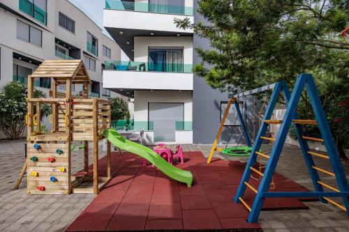 a playground with play equipment in a courtyard at Boutique Apartments Ad Astra in Bibinje