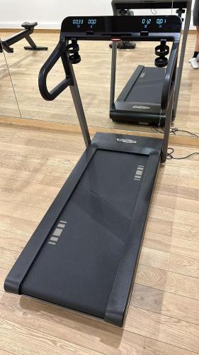 a treadmill sitting on the floor next to a table at Luxurious duplex for 4-7p with large terrace and pool in ski-in ski-out 5 star residence at Les Arcs in Bourg-Saint-Maurice