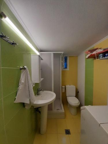 a bathroom with a sink and a toilet at Vasiliki in Kavála