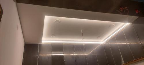 a ceiling with a light in a room at The Dreem House of S Pandey in Prayagraj