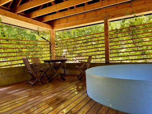 a screened in porch with a table and chairs at Lehtla Puhkekompleks in Austla