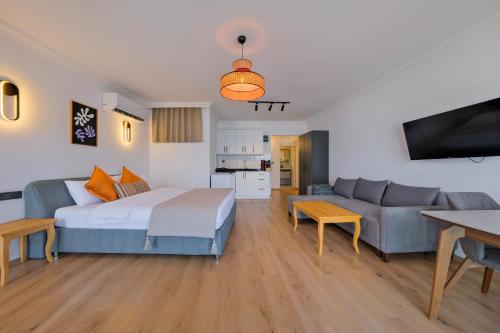 a living room with a large bed and a couch at Körfez Residence in Fethiye