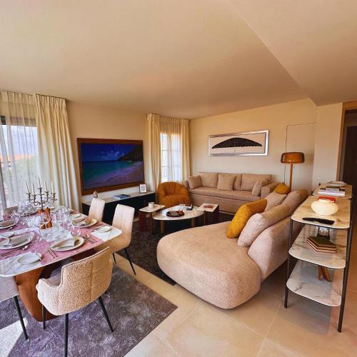 a living room with a couch and a table at VILLTAK SAINT-TROPEZ by VILLTAK Collection in Saint-Tropez