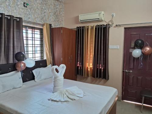 a bedroom with a bed with balloons on it at WB40 Guest House in Durgāpur
