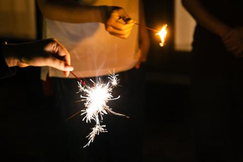 a person holding a sparkler in their hand at 1棟貸切宿 木曽家旅館 しまなみ海道最初の島 supported by COCOSTAY in Onomichi