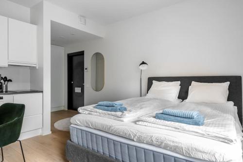 a bedroom with a bed with towels on it at Brand new apartment - Minerva in Turku