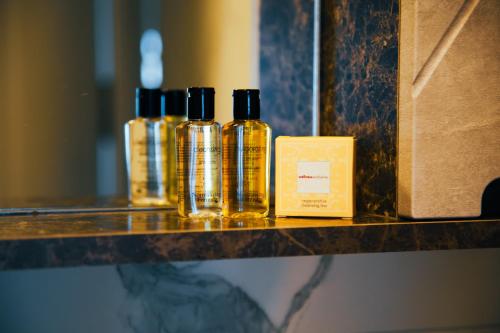three bottles of essential oils sitting on a shelf at Körfez Residence in Fethiye