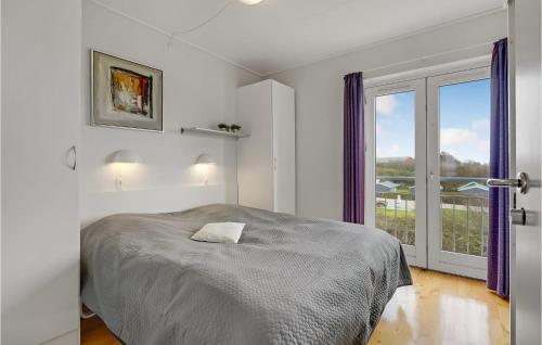 a bedroom with a bed and a large window at 2 Bedroom Stunning Home In Højer in Højer