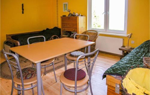 a room with a table and chairs and a couch at Holiday Home Moscienica Moscienicka Ii in Kórnik