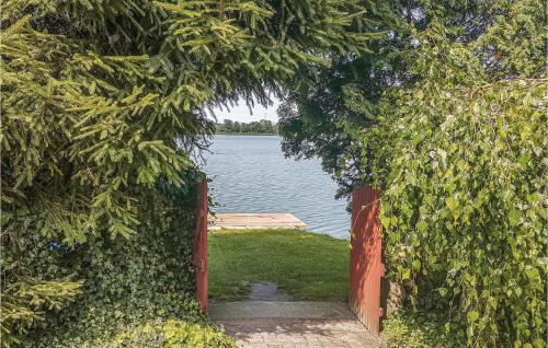 an open gate with a view of a body of water at Holiday Home Moscienica Moscienicka Ii in Kórnik