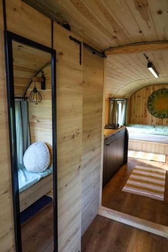 an inside view of a tiny house with wooden walls at Oaza Święty Spokój - domek z balią i jacuzzi in Rząśnik