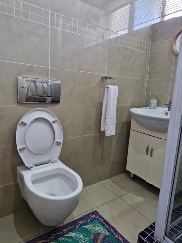 a bathroom with a toilet and a sink at Accommodation Front - Beachfront 3 Sleeper with Ocean Views in Durban