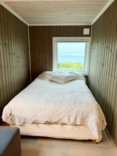 a bed in a room with a window at Amazing seaview - Lodge in Bodø
