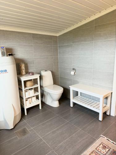 a bathroom with a toilet and a table in it at Amazing seaview - Lodge in Bodø