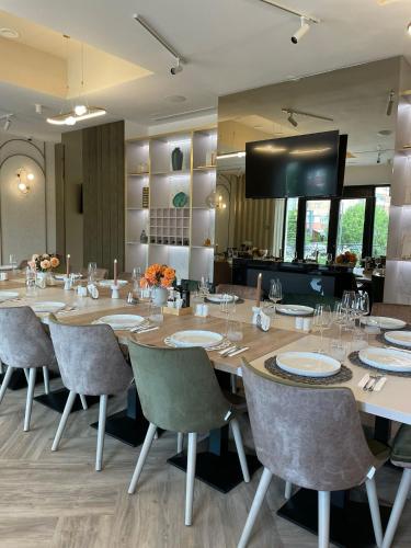 a large dining room with a long table and chairs at Boutique Hotel Balș in Balş