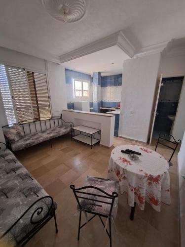 a living room with a table and a couch at Dar Malek instg maleksnor9977 in Al Karm