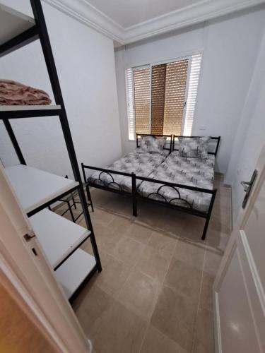 a room with a bunk bed and a window at Dar Malek instg maleksnor9977 in Al Karm