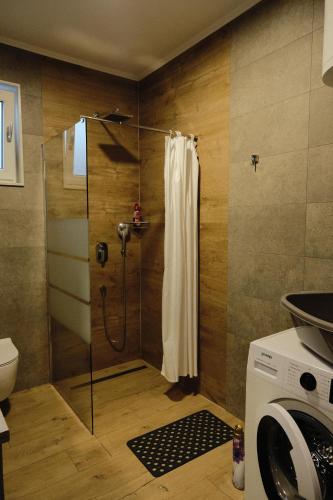 a shower with a glass door in a bathroom at Holiday Resort Bevel in Mostar