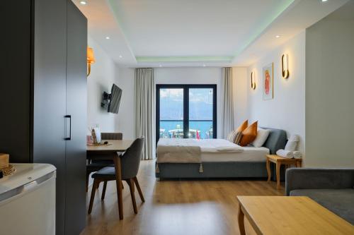 a bedroom with a bed and a desk in a room at Körfez Residence in Fethiye