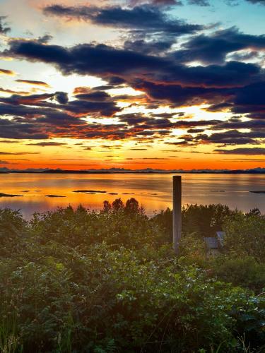 a sunset over a large body of water at Amazing seaview - Lodge in Bodø
