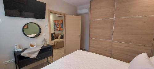 a bedroom with a bed and a mirror and a closet at Limone d'oro in Artemida