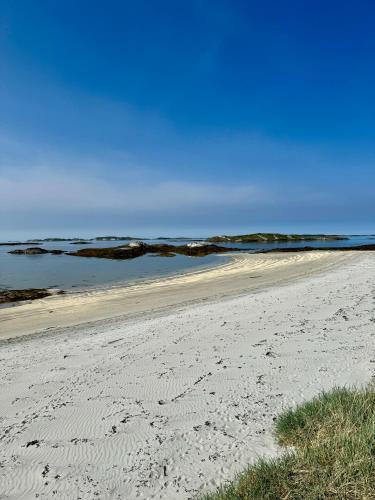 a sandy beach with the ocean in the background at Amazing seaview - Lodge in Bodø