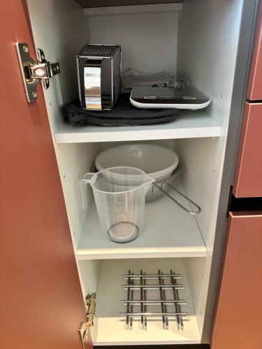 a cupboard with a toaster oven and a blender at Das Alpenzeit Appartement mit Just Private Terrasse in Bad Aussee