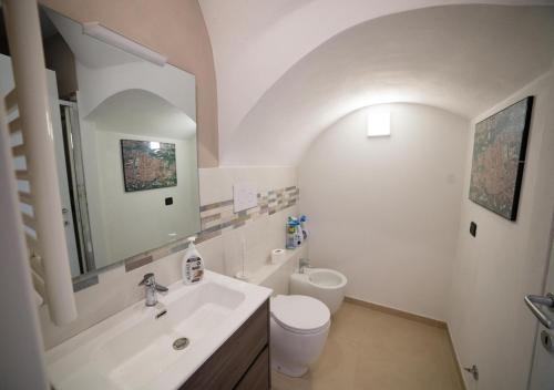 a bathroom with a sink and a toilet and a mirror at "GOOD LIFE" Manicone Housing & More in Vico del Gargano