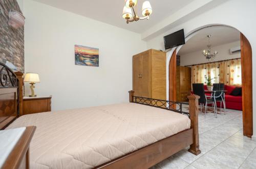 a bedroom with a bed and a living room at Orama Apartments in Agia Anna Naxos