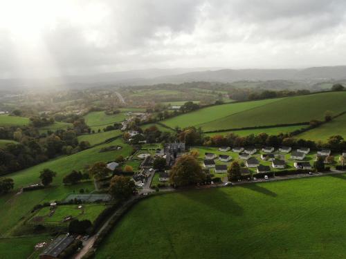 an aerial view of a village in a green field at Harcombe House Bungalow 3 in Newton Abbot