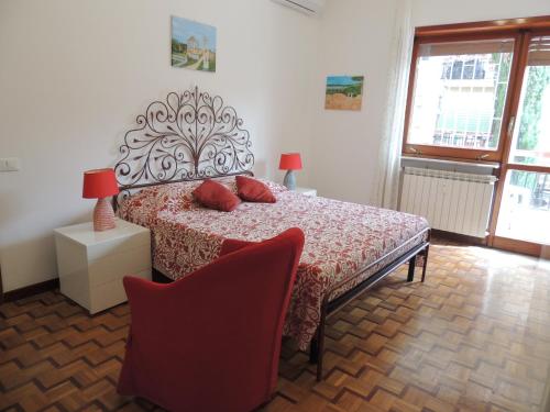 a bedroom with a bed with red pillows on it at La casa di Maro in Lido di Ostia